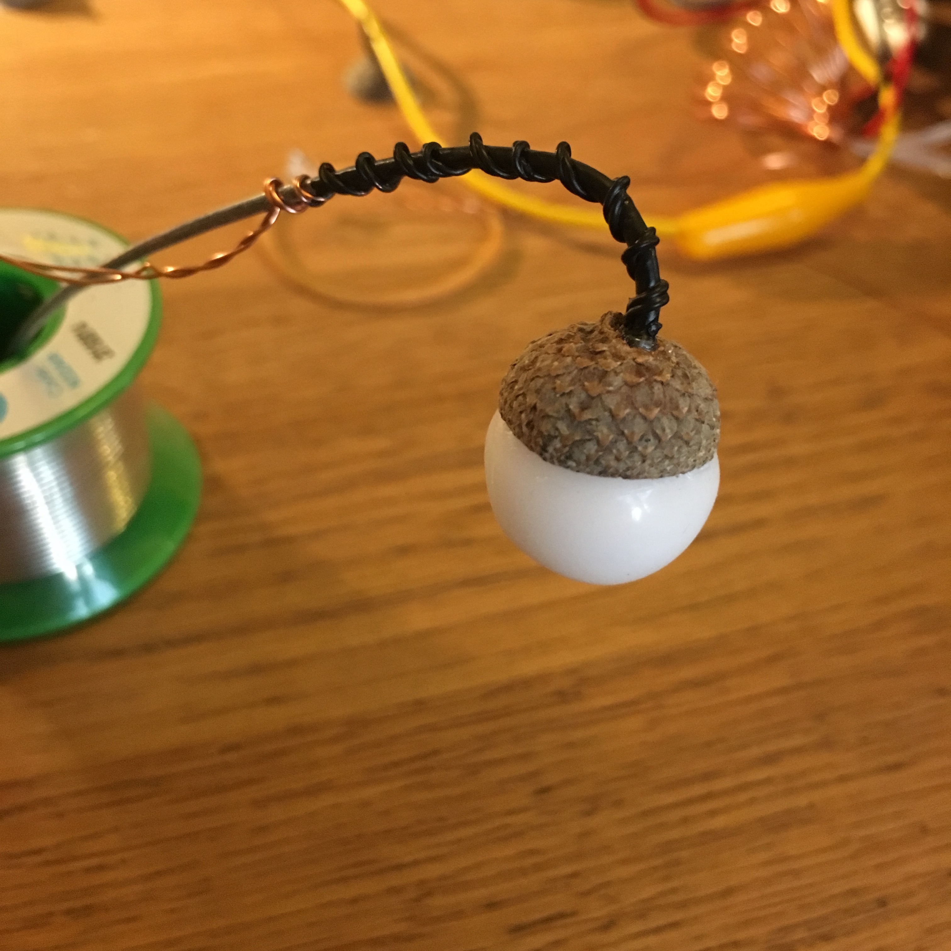 Wire leads to a white orb topped with an acorn cap